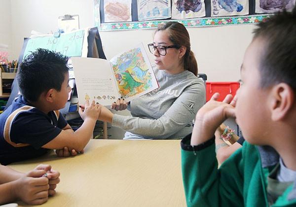 Student reading to children